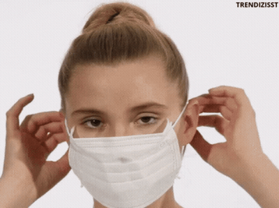 A Woman Wearing A White Face Mask With The Word Trendizisst Behind Her GIF
