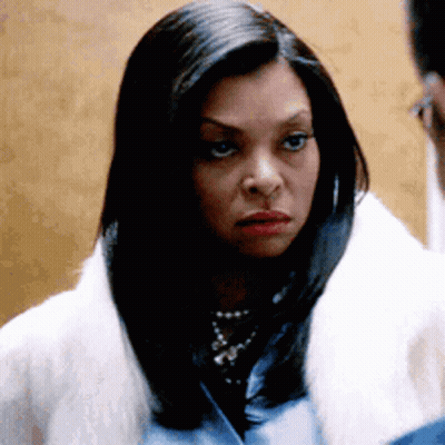 A Woman Wearing A White Fur Coat And A Blue Shirt Is Looking At A Man . GIF