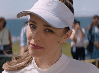 A Woman Wearing A White Hat And Visor With A Leaf On It GIF
