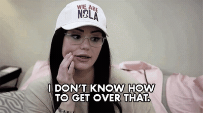 A Woman Wearing A White Hat That Says " We Are Nola " GIF