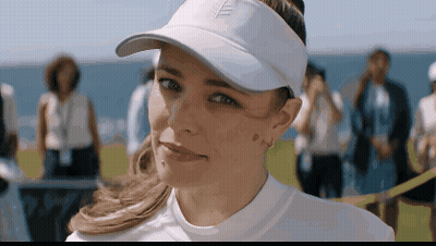 A Woman Wearing A White Hat With A Leaf On The Front GIF