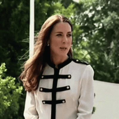 A Woman Wearing A White Jacket With Black Stripes On The Sleeves GIF