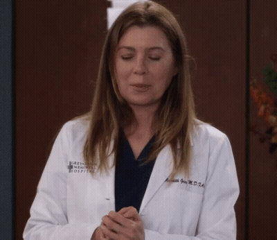 A Woman Wearing A White Lab Coat That Says Grey 'S Anatomy Medical Hospital GIF