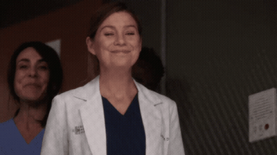A Woman Wearing A White Lab Coat With The Letters A.p.m.s. On It GIF