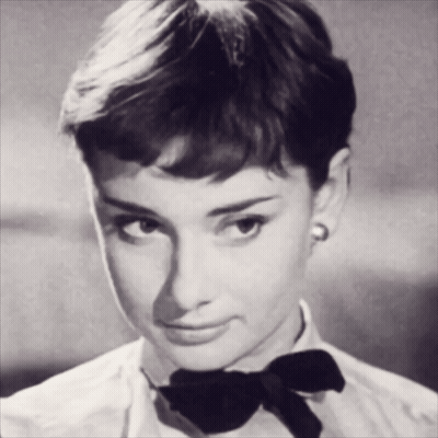 A Woman Wearing A White Shirt And A Black Bow Tie GIF