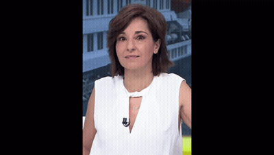 A Woman Wearing A White Shirt And A Necklace With A Microphone On Her Neck GIF
