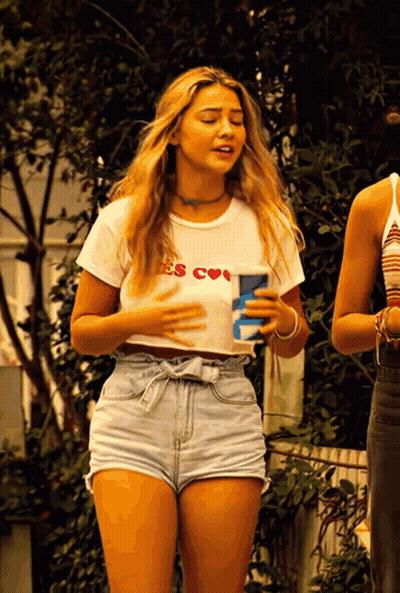 A Woman Wearing A White Shirt That Says ' E 'S Cool ' GIF