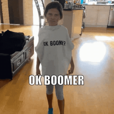 A Woman Wearing A White Shirt That Says Ok Boomer On It GIF