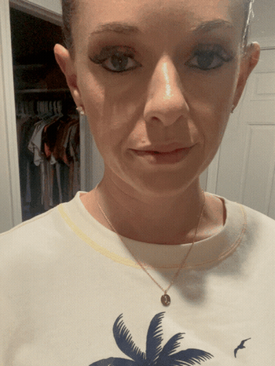 A Woman Wearing A White Shirt With A Palm Tree And A Bird On It GIF
