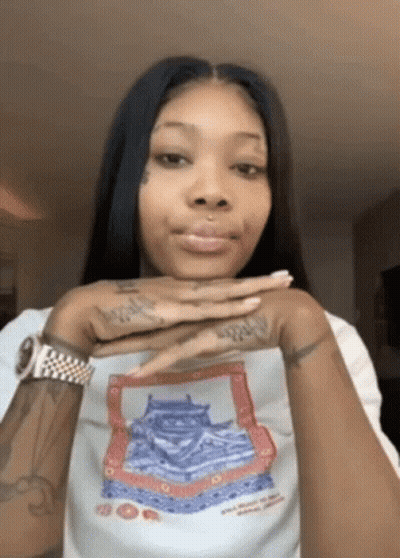 A Woman Wearing A White Shirt With A Picture Of A Castle On It . GIF