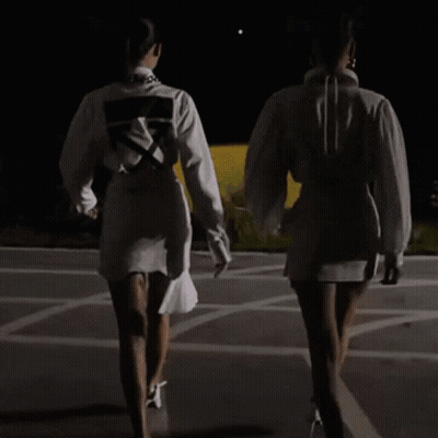 A Woman Wearing A White Shirt With An Arrow On It GIF