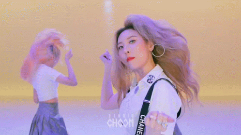 A Woman Wearing A White Shirt With Chanel Straps GIF