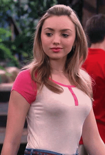 A Woman Wearing A White Shirt With Pink Sleeves And Jeans GIF