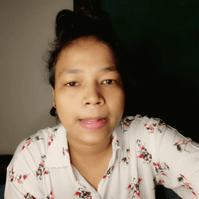 A Woman Wearing A White Shirt With Red And Black Flowers GIF