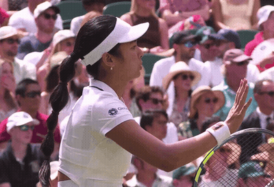 A Woman Wearing A White Shirt With The Word Global On It Holds A Tennis Racquet GIF