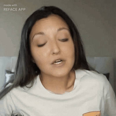 A Woman Wearing A White T-Shirt Is Making A Funny Face . GIF