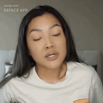 A Woman Wearing A White T-Shirt Is Making A Funny Face With Her Eyes Closed GIF