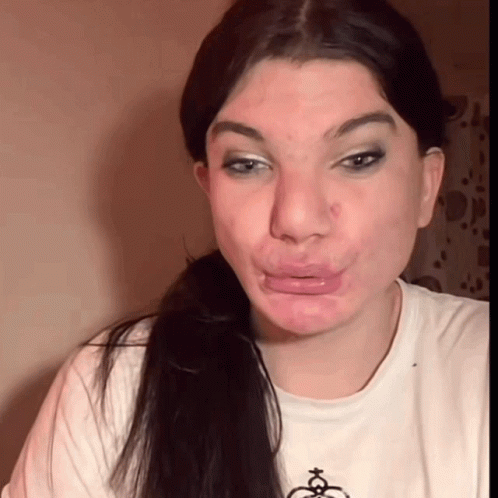 A Woman Wearing A White T-Shirt With A Christmas Tree On It Makes A Funny Face GIF