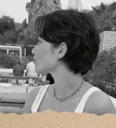 A Woman Wearing A White Tank Top And A Necklace GIF