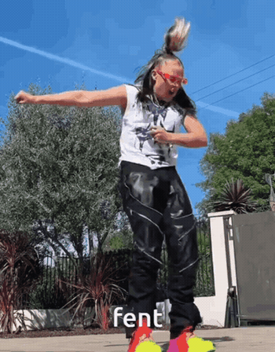 A Woman Wearing A White Tank Top And Black Pants Is Dancing With The Word Fent On The Bottom Right GIF