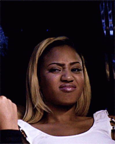 A Woman Wearing A White Tank Top Making A Funny Face GIF