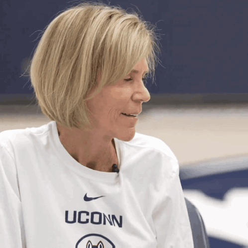 A Woman Wearing A White Uconn Shirt GIF