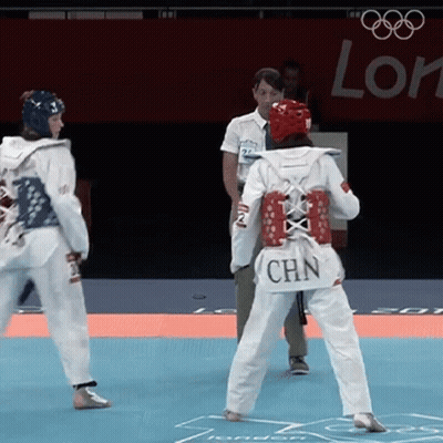 A Woman Wearing A White Uniform With Chn On The Back GIF