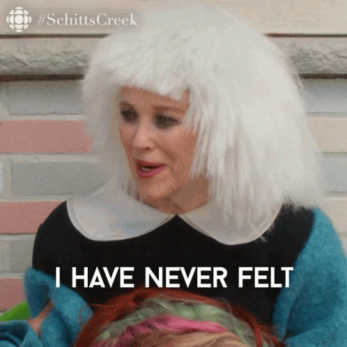 A Woman Wearing A White Wig And A Blue Sweater Says I Have Never Felt GIF