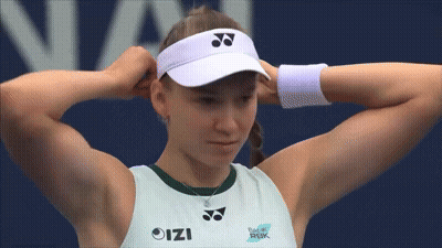 A Woman Wearing A White Yonex Visor Adjusts Her Hat GIF