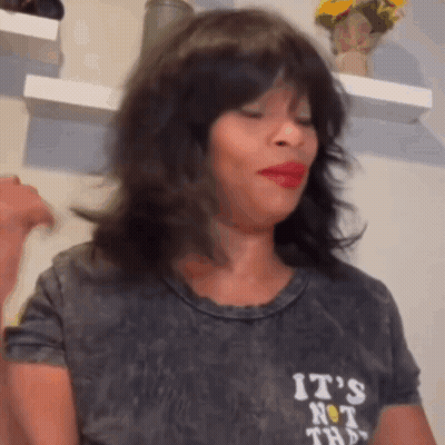 A Woman Wearing A Wig And A T-Shirt That Says `` It 'S Not That '' GIF