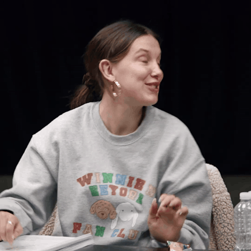 A Woman Wearing A Winnie The Pooh Fan Club Shirt GIF