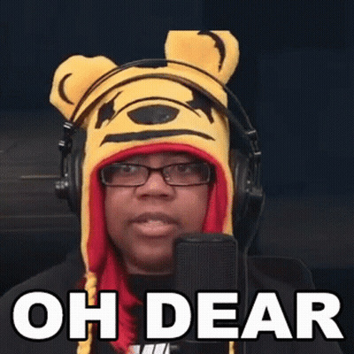 A Woman Wearing A Winnie The Pooh Hat And Headphones Is Speaking Into A Microphone . GIF