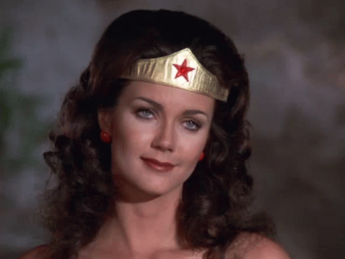 A Woman Wearing A Wonder Woman Headband With A Red Star GIF