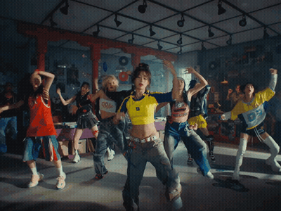 A Woman Wearing A Yellow And Blue Shirt With The Letter O On It GIF