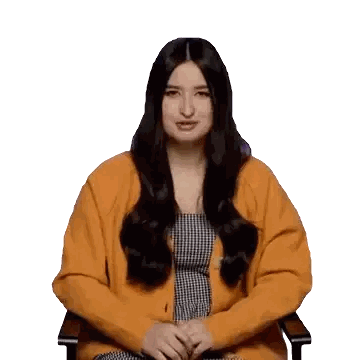 A Woman Wearing A Yellow Cardigan And A Black And White Dress Sits In A Chair Sticker