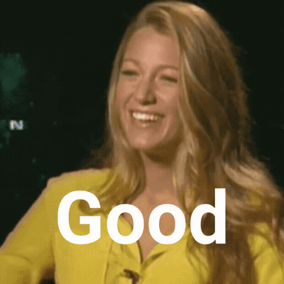 A Woman Wearing A Yellow Jacket Is Smiling And The Word Good Is Visible Behind Her GIF