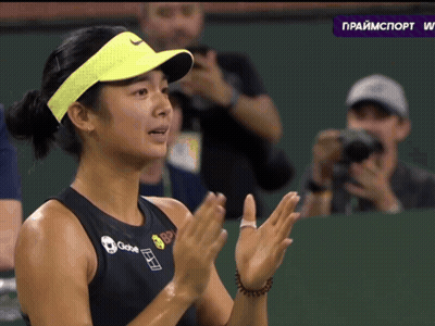 A Woman Wearing A Yellow Nike Visor Is Clapping GIF
