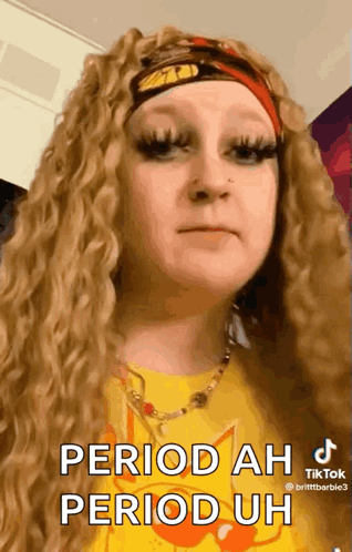 A Woman Wearing A Yellow Shirt And A Red Headband Says " Period Ah Period Uh " GIF