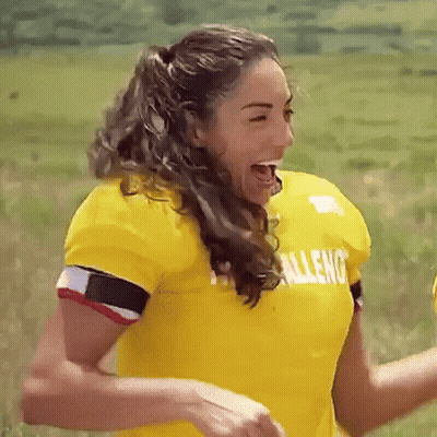 A Woman Wearing A Yellow Shirt That Says Balleno On It GIF