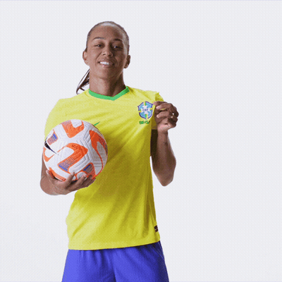 A Woman Wearing A Yellow Shirt That Says Brasil On It GIF
