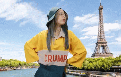 A Woman Wearing A Yellow Shirt That Says Crump GIF