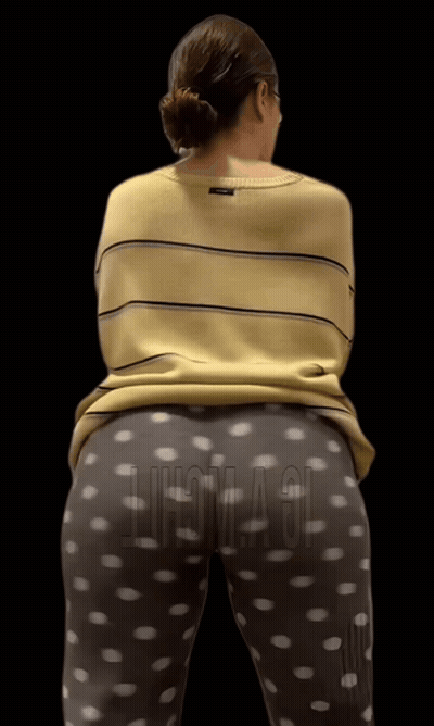 A Woman Wearing A Yellow Striped Shirt And Polka Dot Pants Stands In Front Of A Black Background That Says Chicago GIF