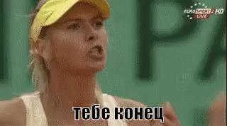 A Woman Wearing A Yellow Visor And A White Tank Top Is Talking To Someone In A Foreign Language . GIF