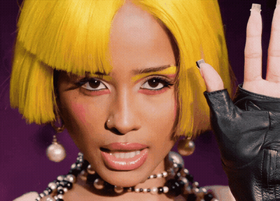 A Woman Wearing A Yellow Wig And A Black Glove GIF
