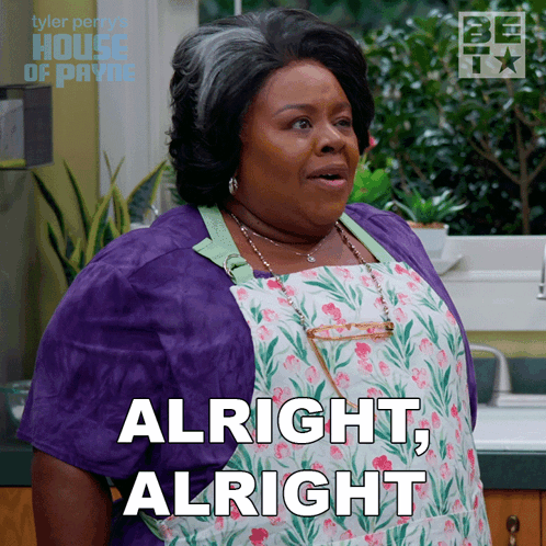 A Woman Wearing An Apron And A Purple Jacket Says " Alright Alright " GIF