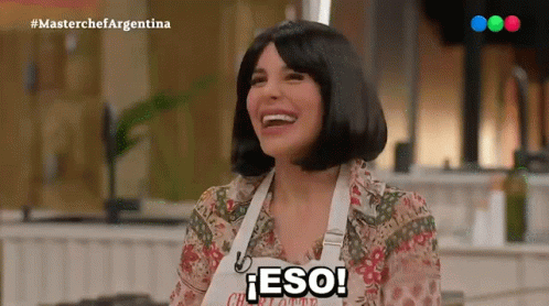 A Woman Wearing An Apron That Says Eso Is Laughing GIF