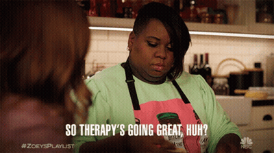 A Woman Wearing An Apron That Says " So Therapy 'S Going Great Huh " Talks To Another Woman GIF