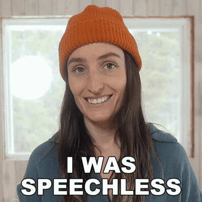 A Woman Wearing An Orange Hat Is Smiling And Says I Was Speechless GIF