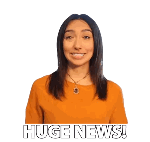 A Woman Wearing An Orange Sweater And A Necklace Says Huge News Sticker