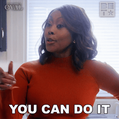 A Woman Wearing An Orange Sweater Says You Can Do It GIF